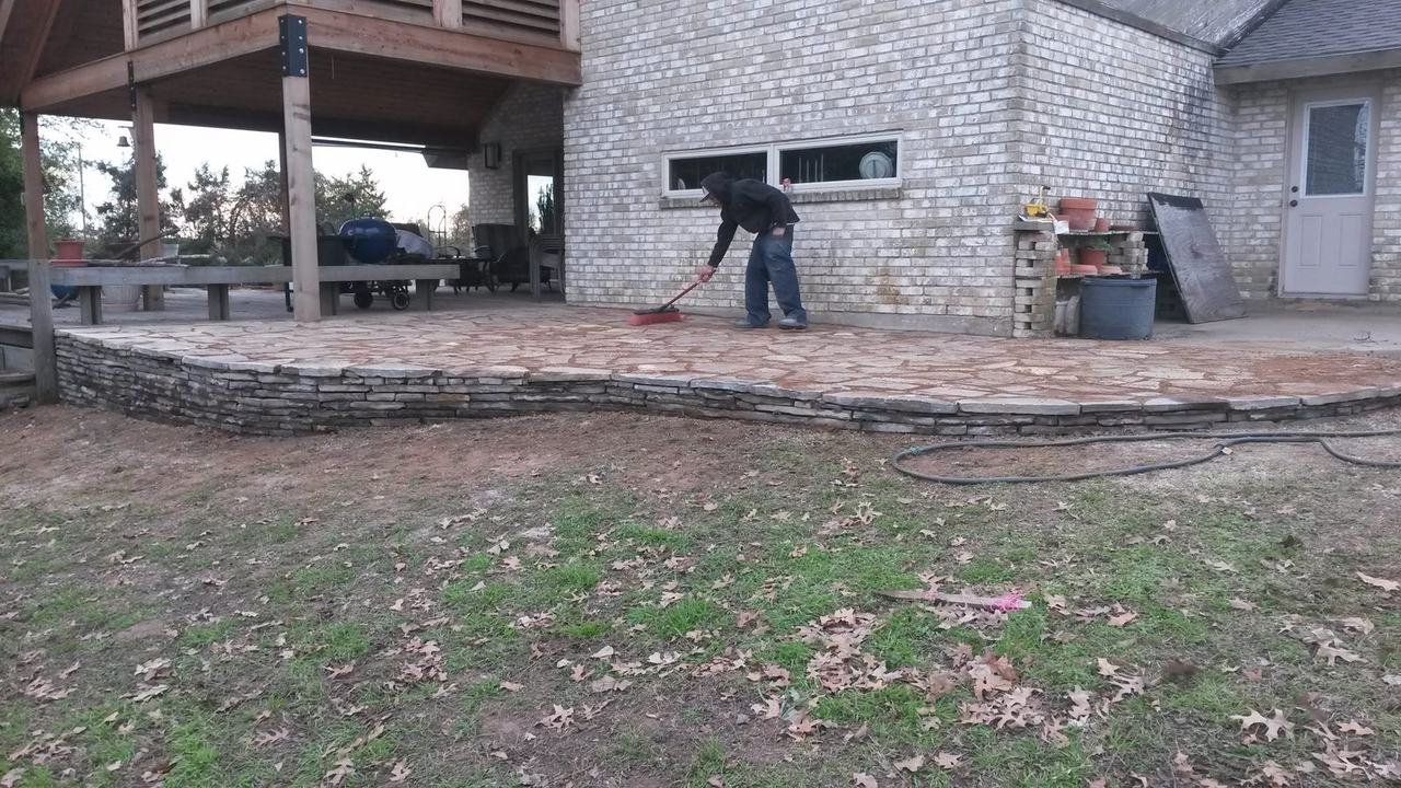 Flagstone patio with a low stone wall near New Ulm, TX