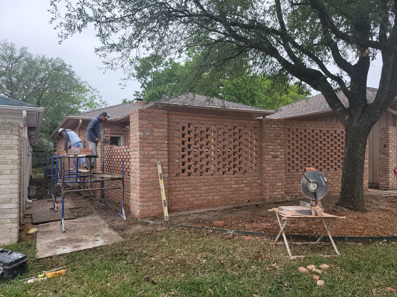 Decorative brick privacy wall with an open pattern under construction in College Station, TX