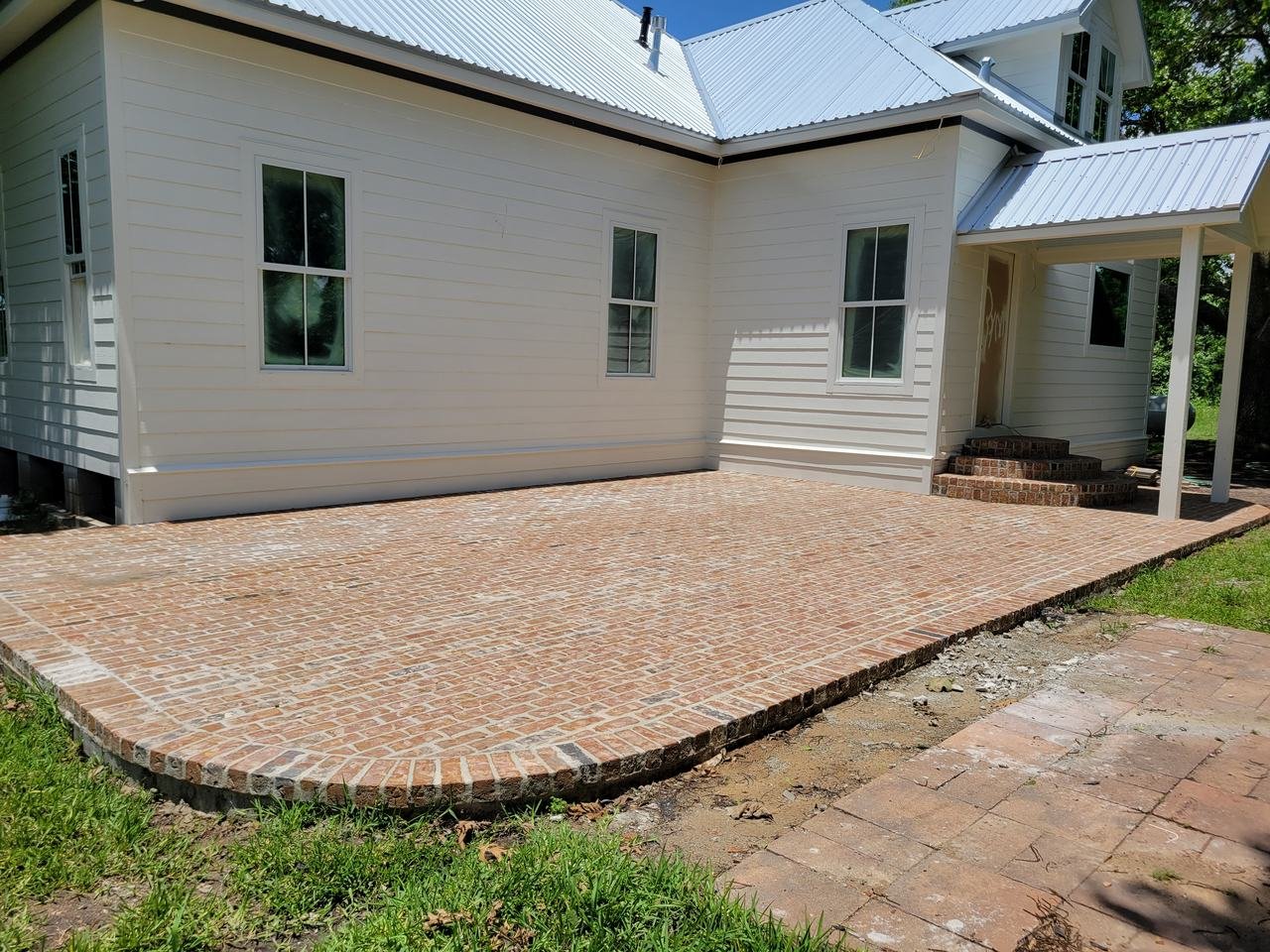 Brick patio along the back of a house near New Ulm, TX