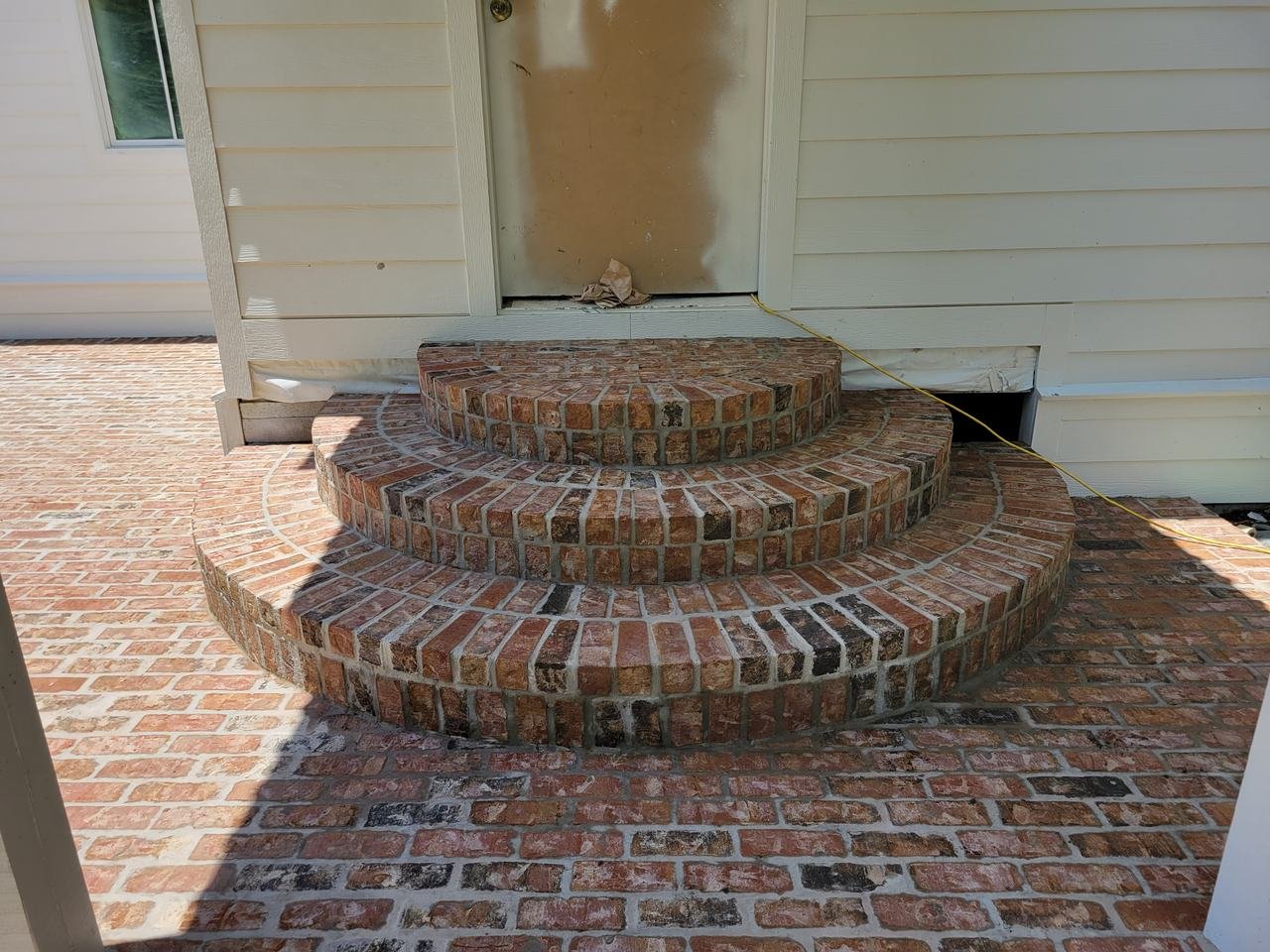 Rounded brick steps at a back door near New Ulm, TX