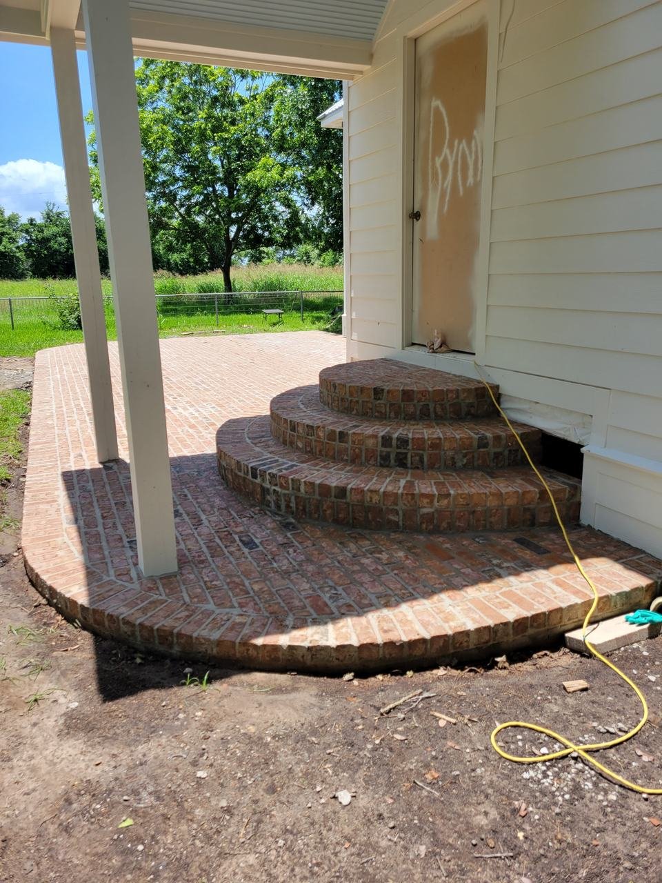 Curved brick steps and patio near New Ulm, TX