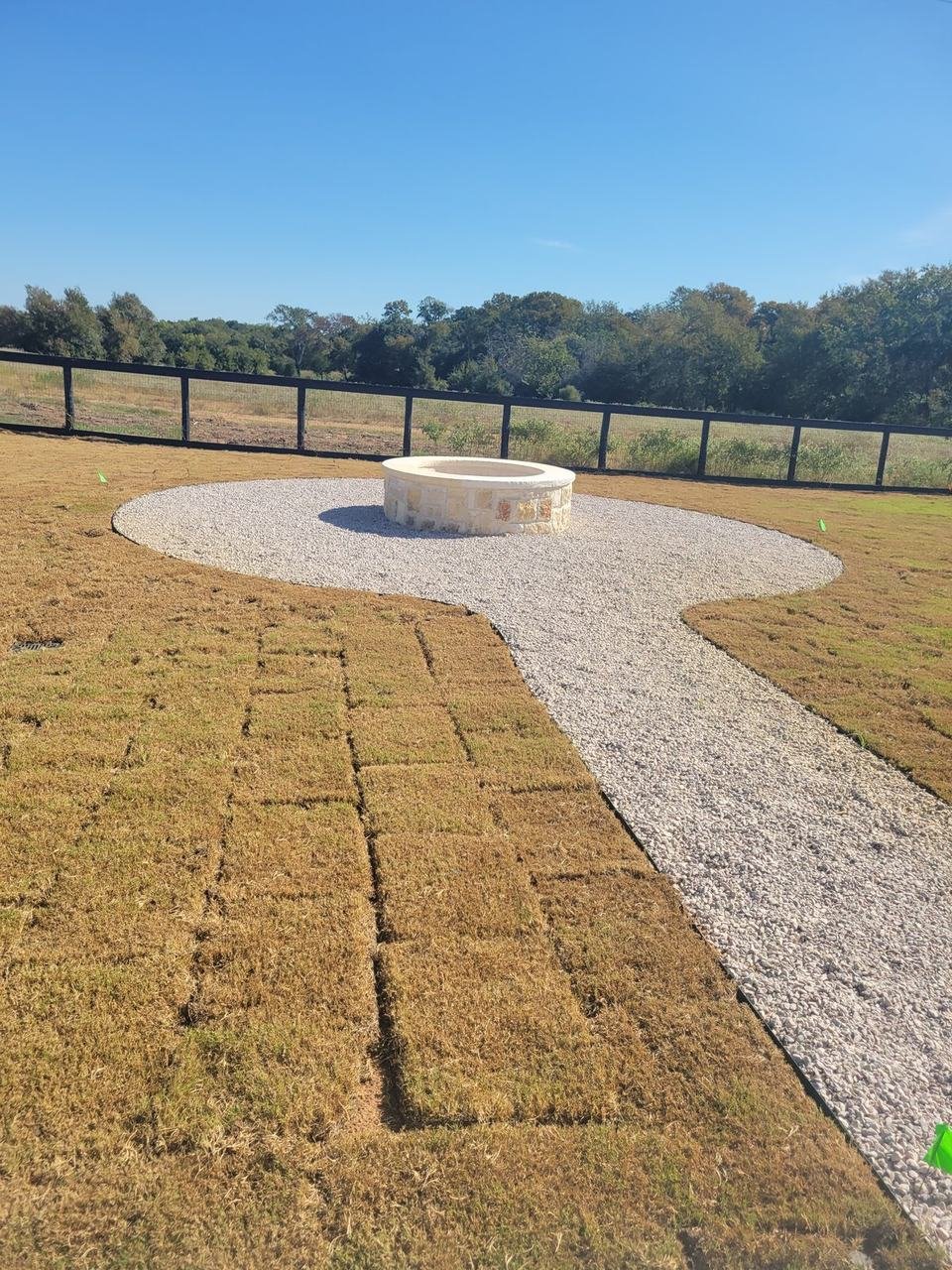 Gravel path leading to a stone fire pit near Fayetteville, TX