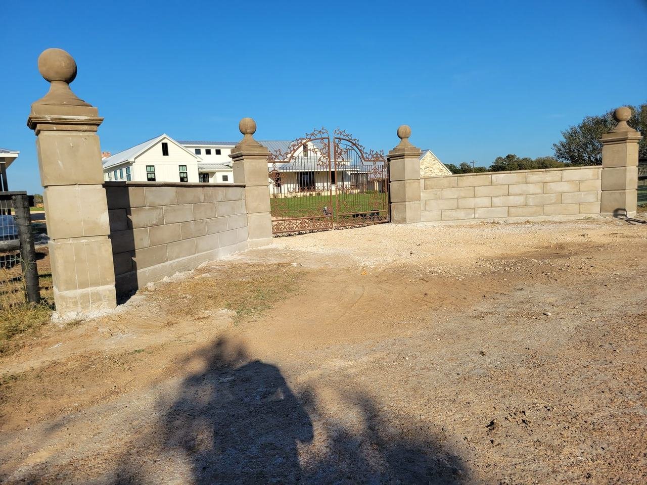 Stone columns and block walls at a driveway entrance near Fayetteville, TX