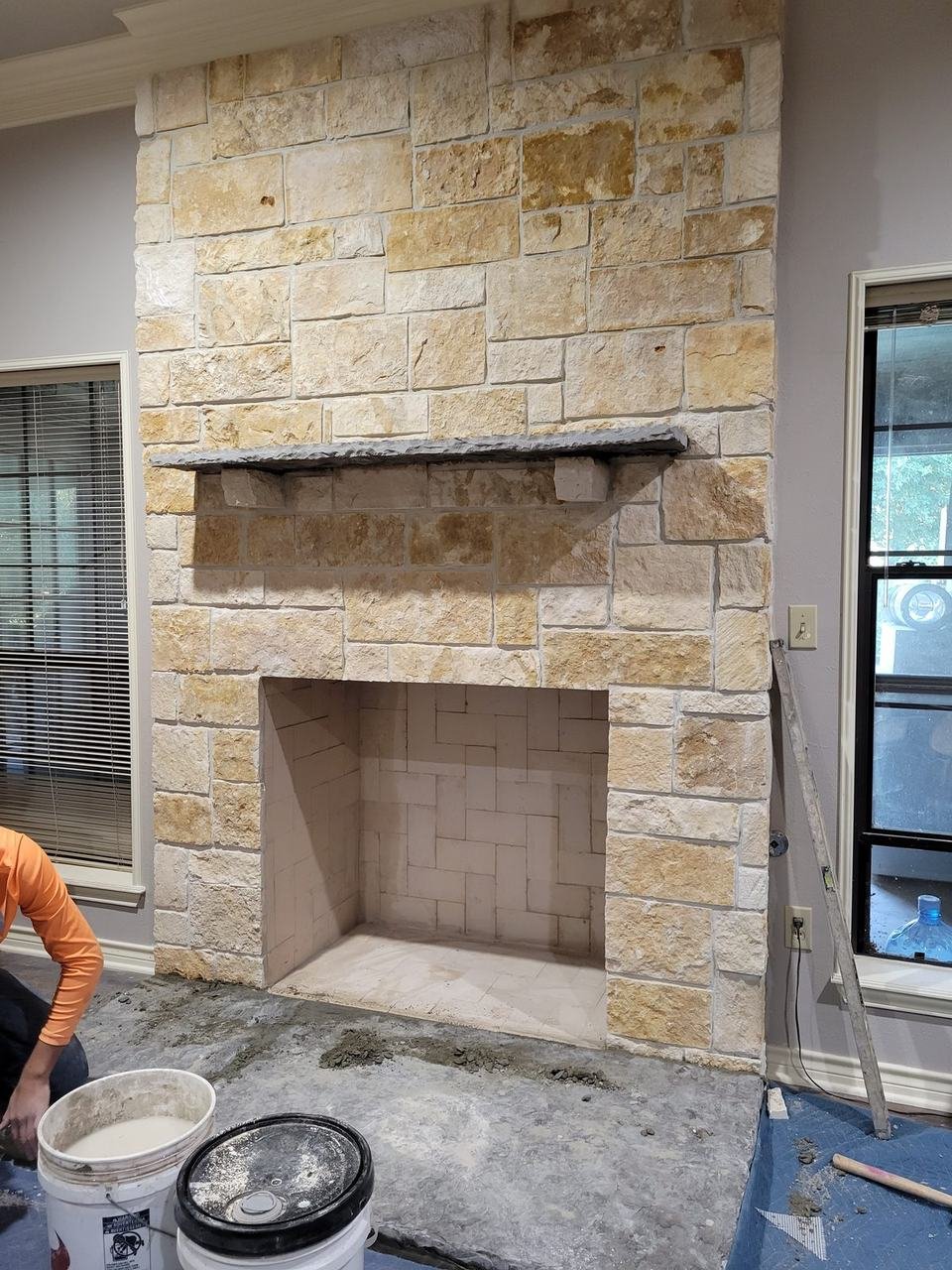 Indoor stone fireplace under construction in College Station, TX