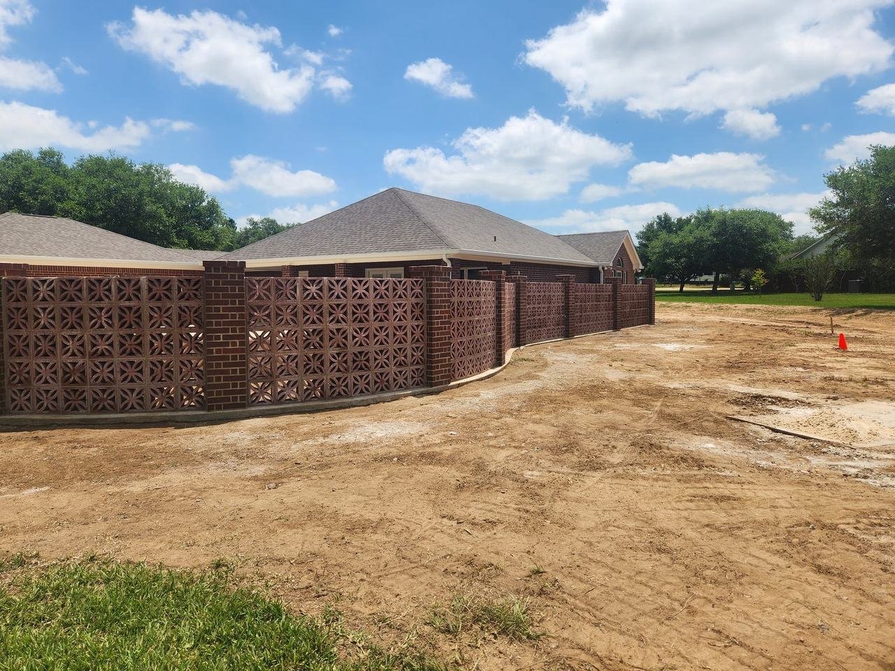 Long decorative brick wall in Bellville, TX