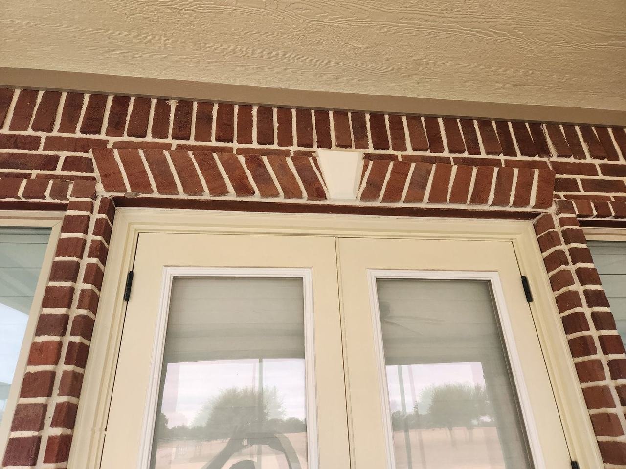 Brick arch detail above French doors in Caldwell, TX