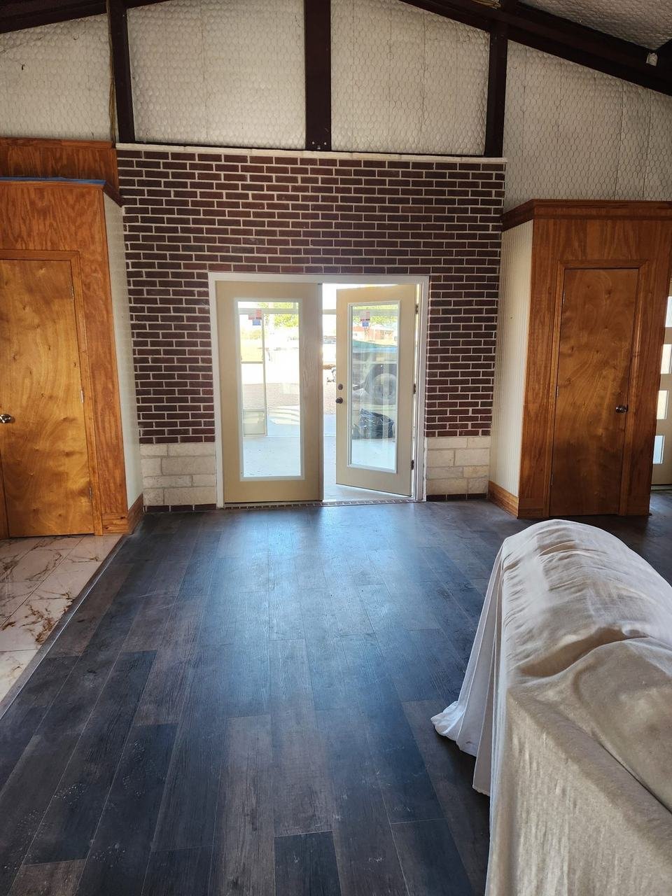 Brick wall and French doors seen from inside in Caldwell, TX