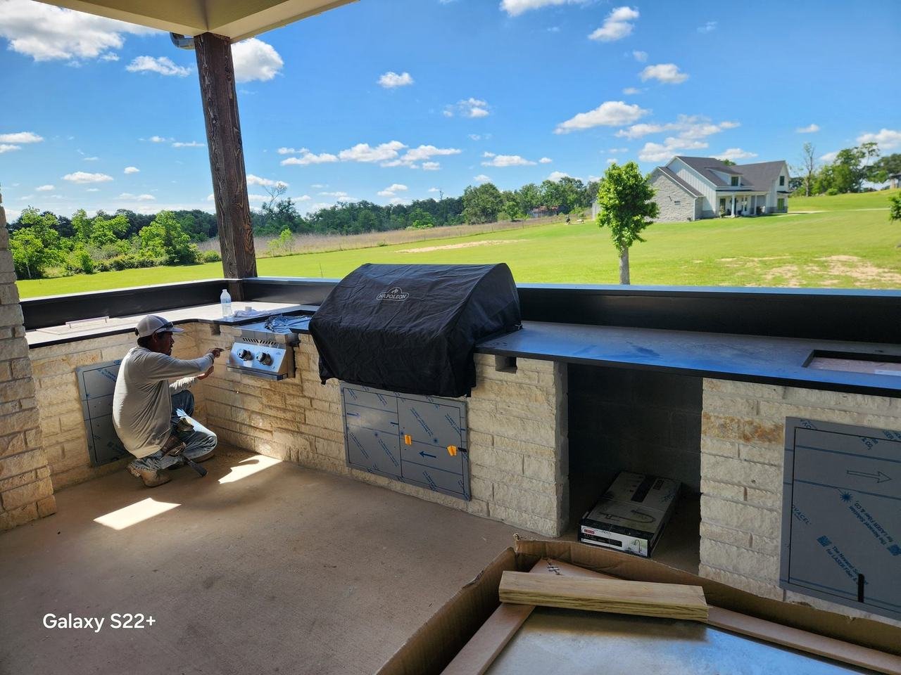 Built-in grill in a stone outdoor kitchen in Bellville, TX