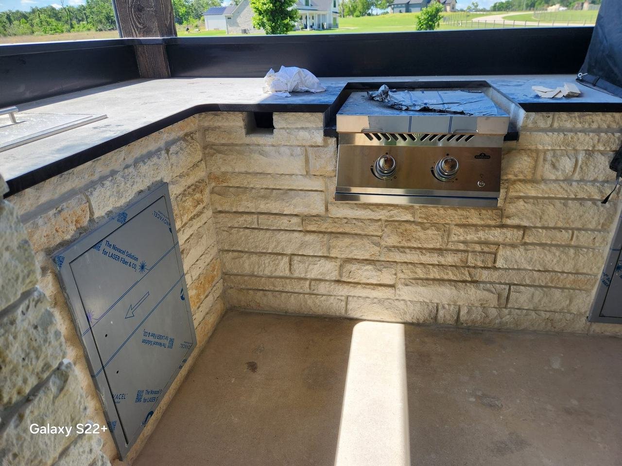 Stone outdoor kitchen cabinets and countertop in Bellville, TX