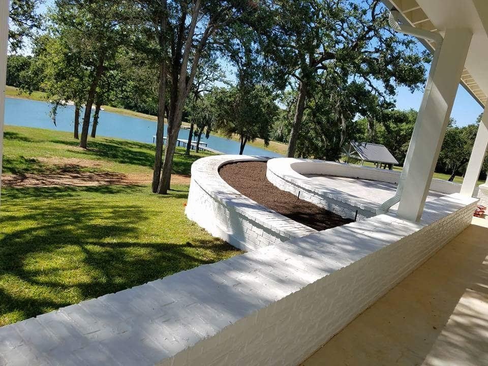 Finished curved brick wall beside a porch near Fayetteville, TX