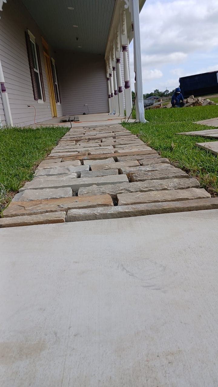 Stone walkway next to a concrete drive near Fayetteville, TX