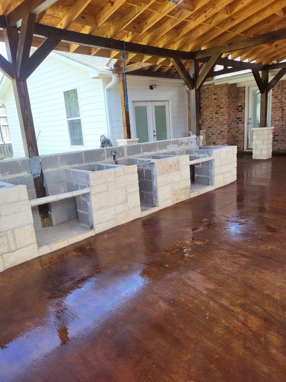 Stone outdoor kitchen under a covered patio in College Station, TX
