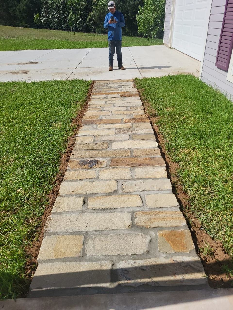 Finished stone walkway between lawn areas near Fayetteville, TX