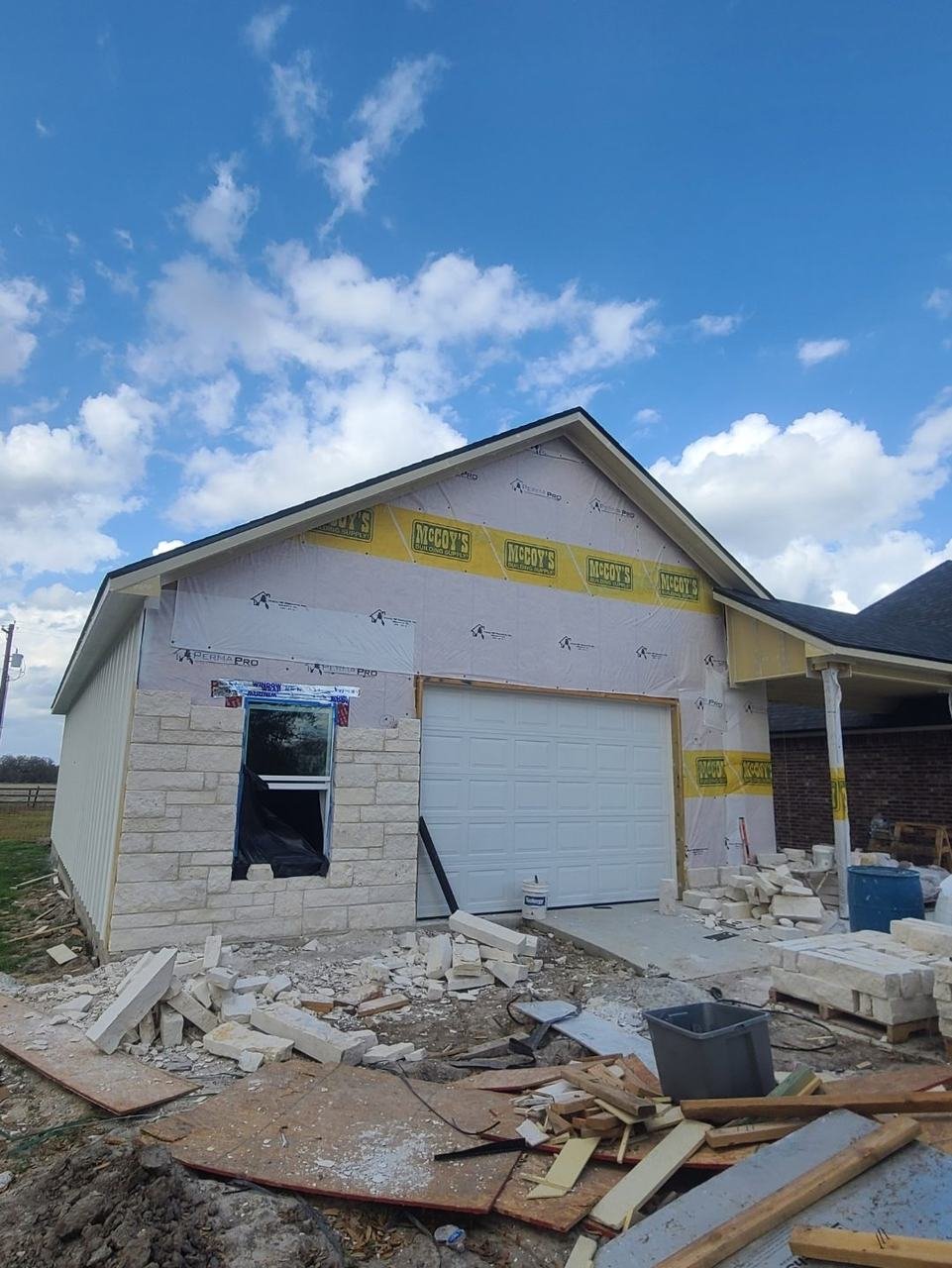 Stone siding being installed on a shop building in College Station, TX