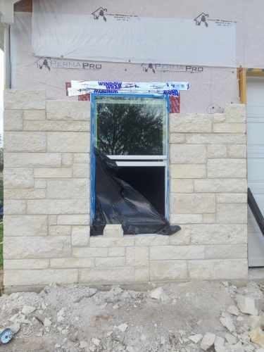 Cut stone siding around a window on a shop building in College Station, TX