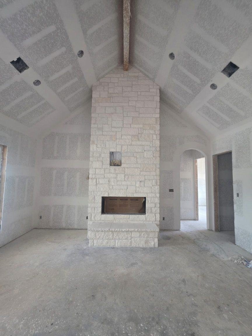 Floor-to-ceiling natural stone fireplace in a new home in Chappell Hill, TX