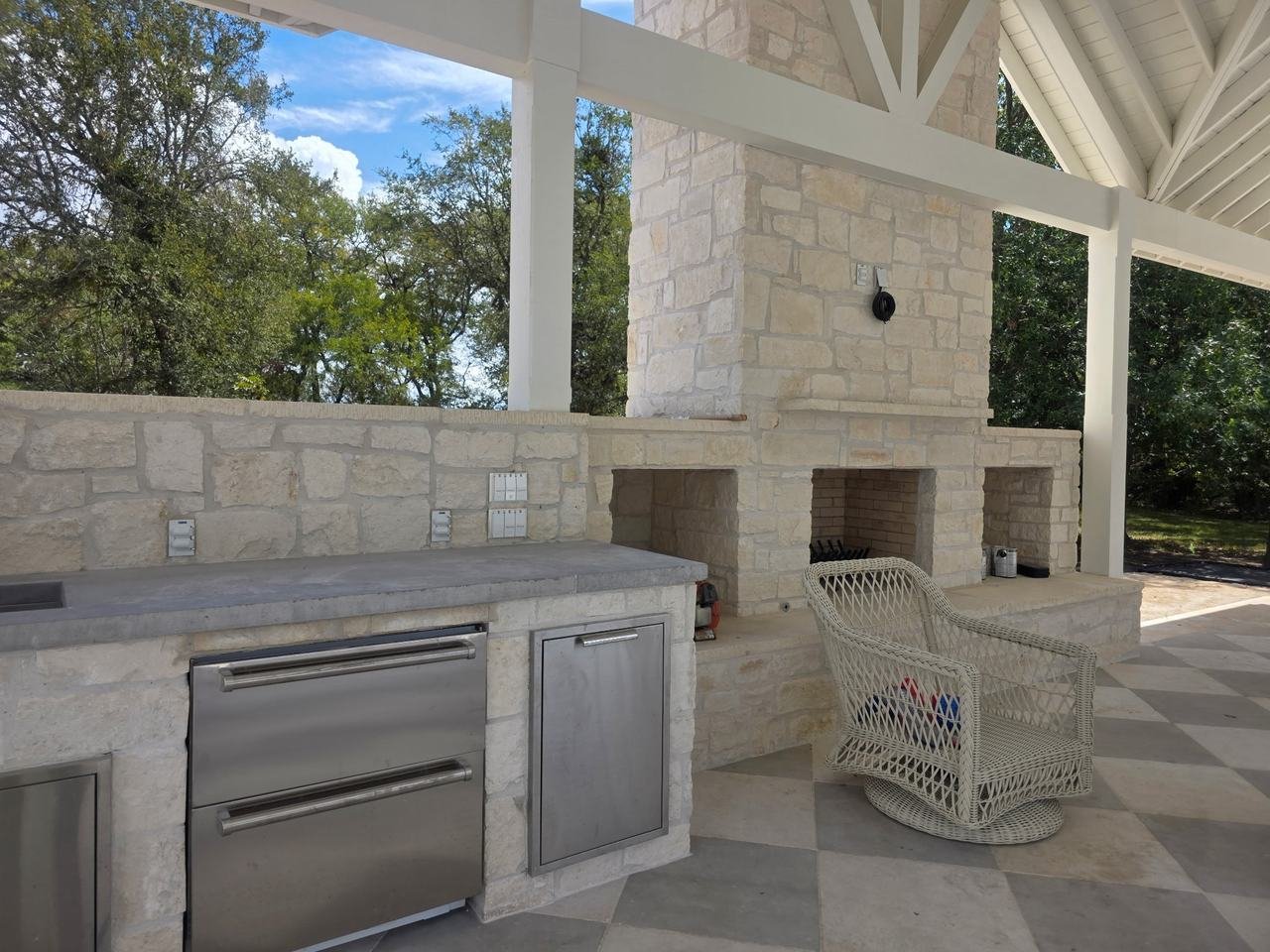 Stone fireplace and outdoor kitchen counter in Burton, TX